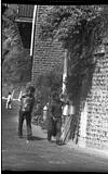 Laborers carrying milk in cans, 1985