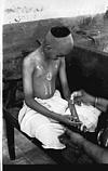 Pradeep anointing sandal paste after ceremonial bath, 1982