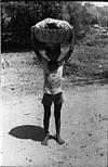 Boy carrying food to field, 1985