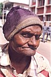 The worn out cap of a homeless man