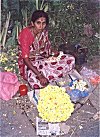 A housewife selling flowers for extra earnings.