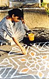 She commenced her rangoli early in the morning.