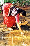 A Woman Spreading Rangoli