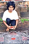 This gal spreads the special Pongal rangoli.