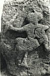 A memorial stone showing a furiously fighting hero