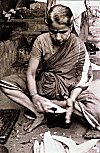 Woman Cutting Vegetables on a Stationary Knife (Adoli)