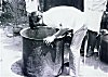 A Professional Cook Inspecting a Curry Vessel