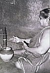 Ederly Woman Using Pulleys to Churn and Produce Butter