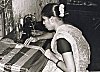 A Woman Making Quilts By Stitching Old Sarees