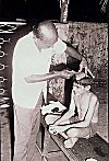 Expert barber shaving off the Vatu's head