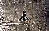 Girl bathing in a public pond