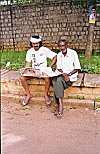 A Literate Man Reads Political News to an Illiterate Friend
