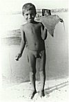 Naked Fisherman boy with his ray fish catch