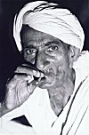 Man smoking bidi (hand-rolled cigarrette)