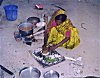 A woman smashing vegetables instead of cutting them