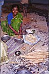 A construction worker preparing dinner on the street