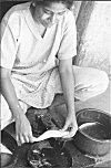 Girl Cleaning Scales of a Fish