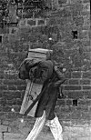 Man Carrying a Tourist's Luggage and Bedding