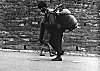 Laborer Transporting Cooking Gas Cylinder on His Back