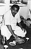 Man on Floor Eating Traditional Meal