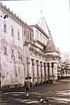 Man Walking by a Goan Temple