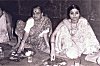 Women Eating Festive Meal on Plantain Leaves