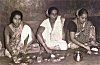 Women Eating Festive Meal on Plantain Leaves