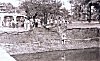 Men Gathered at a Tank