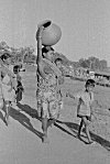 Tribal women balancing work, errands and children