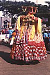 Big man blowing Pungi (a horn instrument)