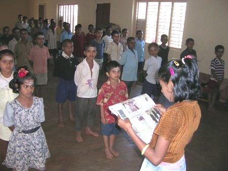 News being Read to Kids at an Orphanage