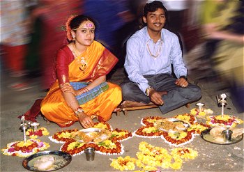 Newly Weds Offering Prayers with Flowers